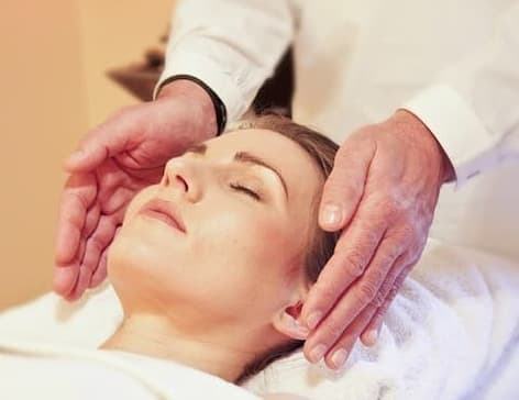 reiki hands hovering near womans head